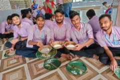 enjoying traditional food boys